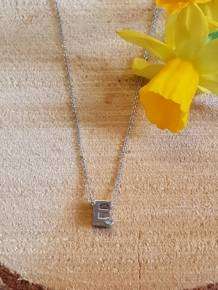 initials letter E met Zirkonia Joy de la Luz